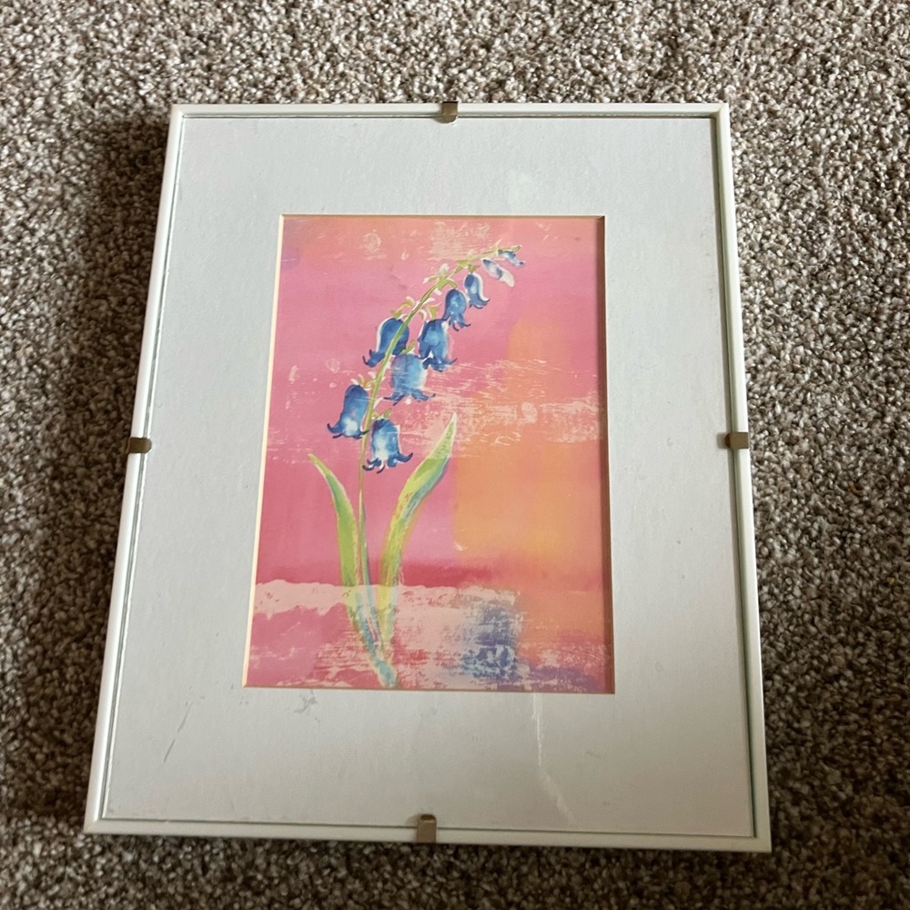 White frame with a floral art print. Perfect for your powder room or hallway.